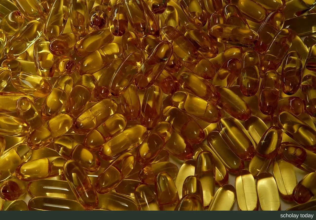 A pile of gelatin softgels containing omega-3 fish oil, the capsules translucent and golden yellow